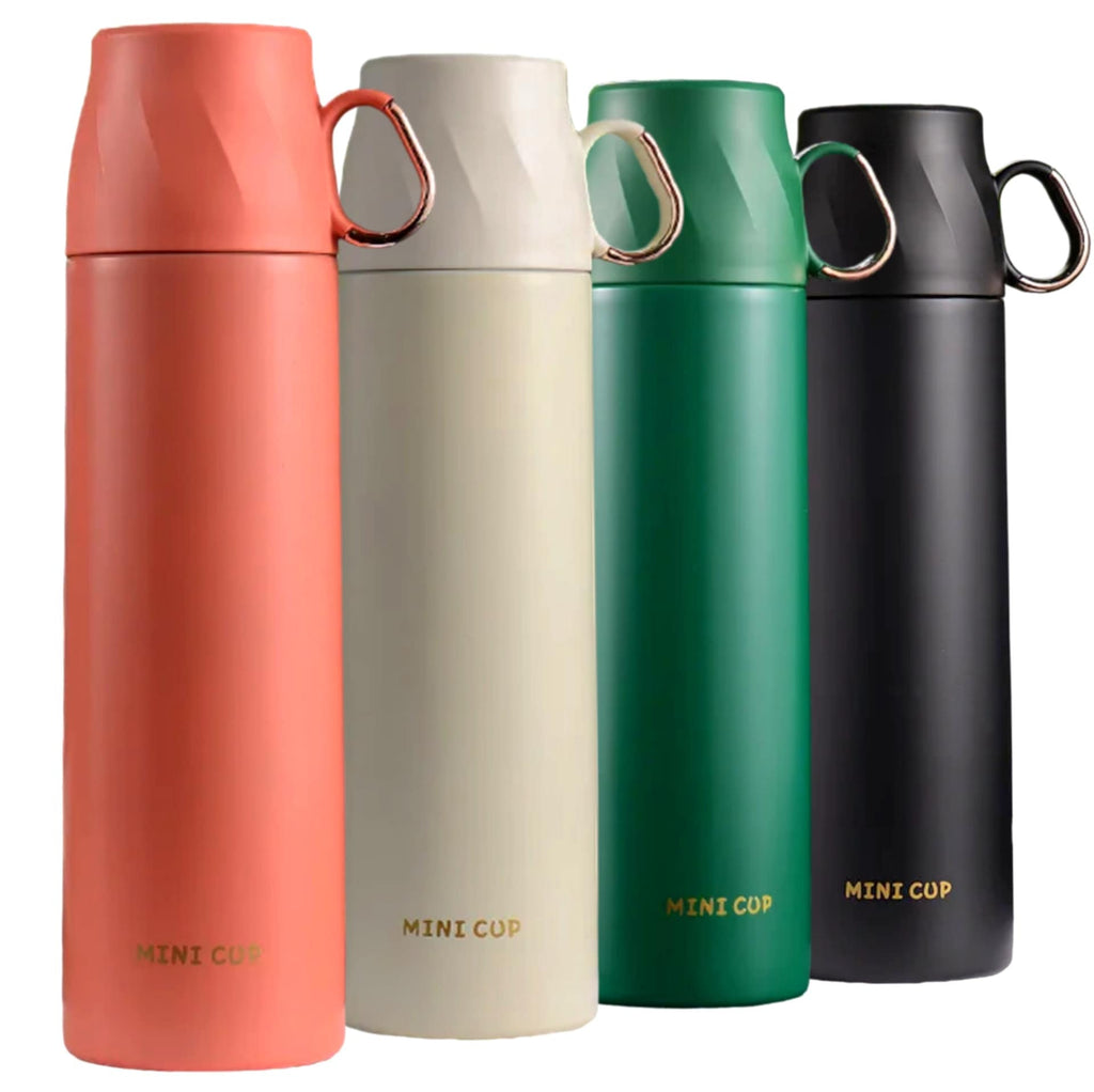 Mini Cup Thermos Flask forest green lifestyle shot being held outdoors by hiker with backpack